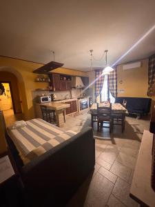 a kitchen and a living room with a bed and a table at A Casa del Ferdy in Caserta