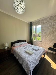 a bedroom with a bed with two towels on it at Svaneti Heaven in Lentekhi +42 photos