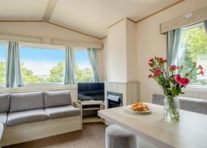 a living room with a couch and a table at Thorness Bay in Porchfield
