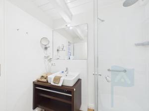 a bathroom with a sink and a shower at Min aran in Oevenum +18 photos