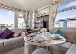 a living room with a table and a couch at Thorness Bay in Porchfield