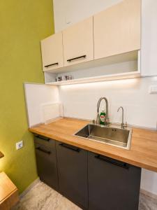 eine Küche mit Spüle und hölzerner Arbeitsplatte in der Unterkunft Hotel Marti Studios in Skala Sotiros