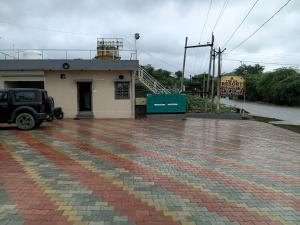 a building with a car parked in front of it at THE GK Resort in Ābu Road +1 photo
