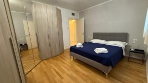 a bedroom with a bed with two towels on it at Aurum Aparthotels Bicocca in Milan