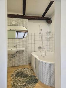 a bathroom with a tub and a sink at Kraska nisa in Komen +13 photos