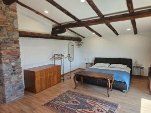 a bedroom with a bed and a table at Kraska nisa in Komen