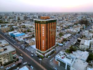 an aerial view of a city with a tall building at Basra Touristic Hotel in Al Başrah