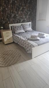 a white bedroom with a bed and a wooden floor at Rifugio del Piemont in Villaretto