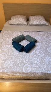 two pillows on top of a bed at Appartement près des Grands Buffets climatisé in Narbonne