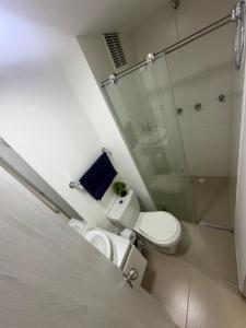 a bathroom with a toilet and a glass shower at Descanso Ideal in Manizales +21 photos