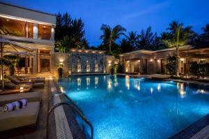 a swimming pool in a house at night at Golden Palace in Kolkata