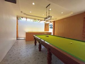 a billiard room with a green pool table at Gn story love บ้านเกาะล้าน 小珊瑚岛班泳池别墅 in Ko Larn