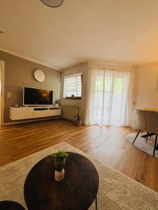a large living room with a table and a tv at Ferienwohnung De Lorenzi in Boppard