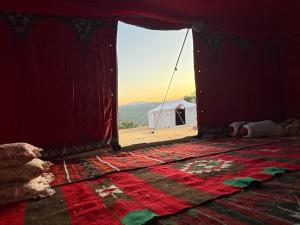 an open door to a tent with a view of the desert at Waatad in Irbid