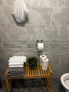 a bathroom with a table with towels and a toilet at Modern Panoramic Sea View Apartment with Large Terrace in Pag +26 photos