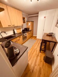 a kitchen with wooden cabinets and a wooden floor at Ferienwohnung De Lorenzi in Boppard +8 photos