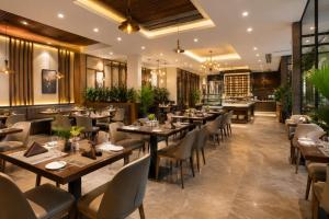 a restaurant with wooden tables and chairs at Golden Palace in Kolkata
