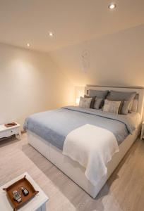 a bedroom with a large bed with a blue blanket at Hostinec U Rypáka in Vrátkov +32 photos
