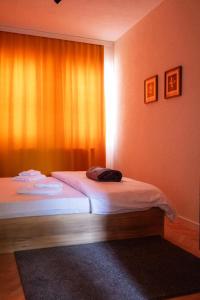 a bedroom with a bed and a window with at UrApartment in Prizren
