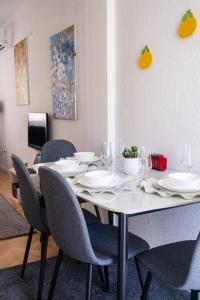 a dining room table with chairs and plates on it at UrApartment in Prizren