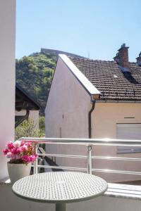a table on the balcony of a house at UrApartment in Prizren