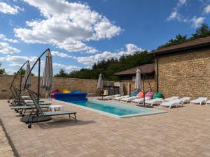 a swimming pool with lounge chairs and a swing at Gracia House in Mogilovo