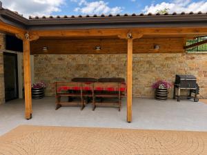 a pavilion with a table and a grill on a patio at Gracia House in Mogilovo +22 photos