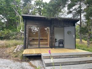 a small cabin on a wooden deck in the woods at The Archipelago Hideaway in Vaxholm