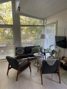 a living room with a couch and a tv at The Archipelago Hideaway in Vaxholm
