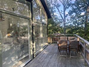 a patio with a table and chairs on a deck at The Archipelago Hideaway in Vaxholm +104 photos