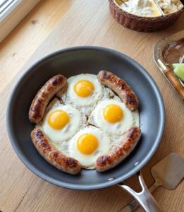 a plate of eggs and sausages on a table at AnArt resort in Vanadzor