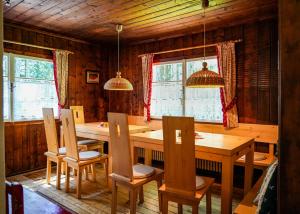 a dining room with a wooden table and chairs at Berghütte - Schwaz - Pillberg in Pill +67 photos