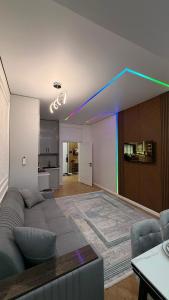 a living room with a couch and a blue line at Capital city in Shymkent