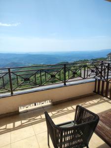 a chair sitting on a balcony with a view at Aurora Kopaonik in Raška