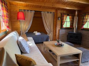 a living room with a couch and a table at Wild Life Chalets in Rafína