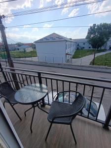 a patio with two chairs and a table on a balcony at VSt GRAND HOTEL in Ninotsminda