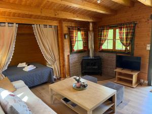 a living room with a couch and a table in a cabin at Wild Life Chalets in Rafína
