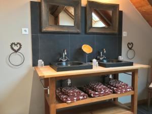 a bathroom with two sinks and chocolate donuts on a shelf at La Clé des Bois in Le Bourg-dʼOisans +50 photos