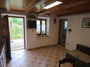 a living room with a door open to a patio at Apartma Dajana in Lokve