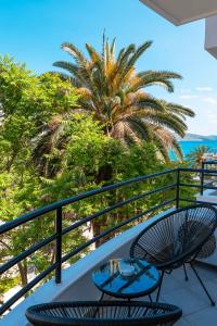 a balcony with a table and chairs and the ocean at Diamond Prestige Hotel in Sarandë