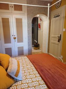 a bedroom with a bed with an orange comforter at La Parenthèse Provençale in Cabasse +38 photos