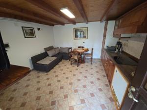 a living room with a couch and a table at Apartma Dajana in Lokve