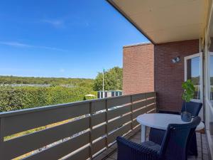 a patio with a table and chairs on a balcony at Texel-De Koog 116 in De Koog
