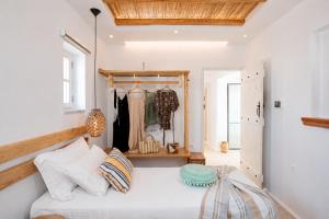 a bedroom with a bed and a clothes rack at Boriadon Rustic Countryside Homes in Naxos Chora +121 photos