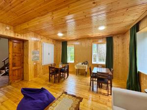 a living room with a table and a dining room at Svaneti Heaven in Lentekhi