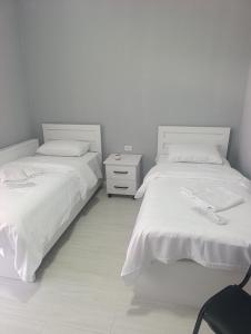 two beds sitting next to each other in a bedroom at VSt GRAND HOTEL in Ninotsminda +19 photos