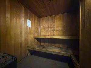 a sauna with a bench in a wooden wall at Puddings Home Compact Apartment State Library in Melbourne +27 photos