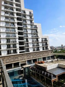 an apartment building with a pool in front of it at Velvet Nook in Greater Noida