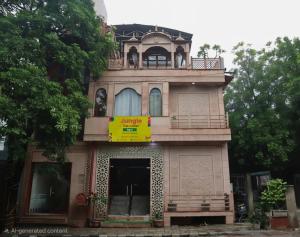 a house with a balcony on top of it at Jungle by sturmfrei Agra in Agra