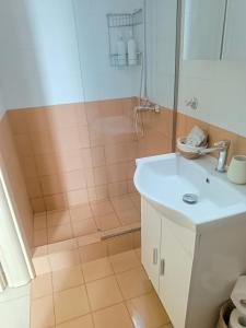 a bathroom with a sink and a shower at Nicol's apartment in Ermoupoli +11 photos